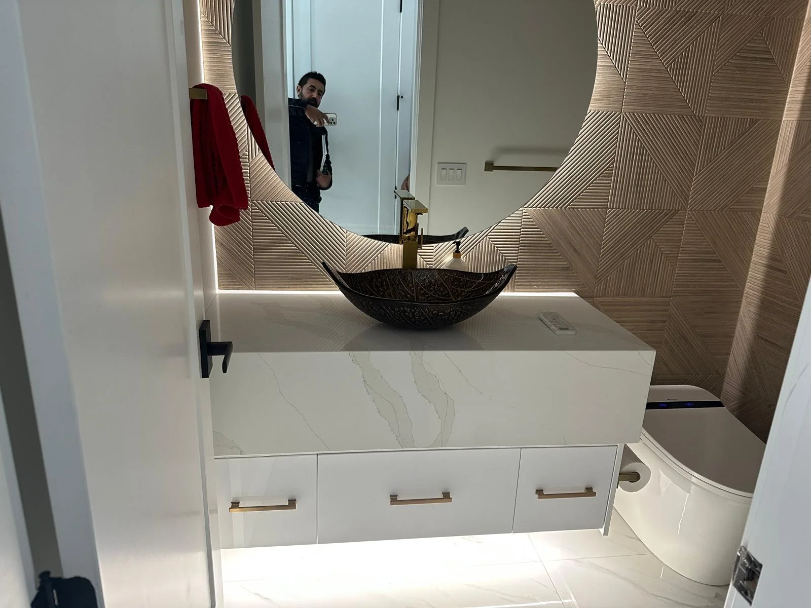 Floating bathroom vanity with stone countertop and vessel sink.