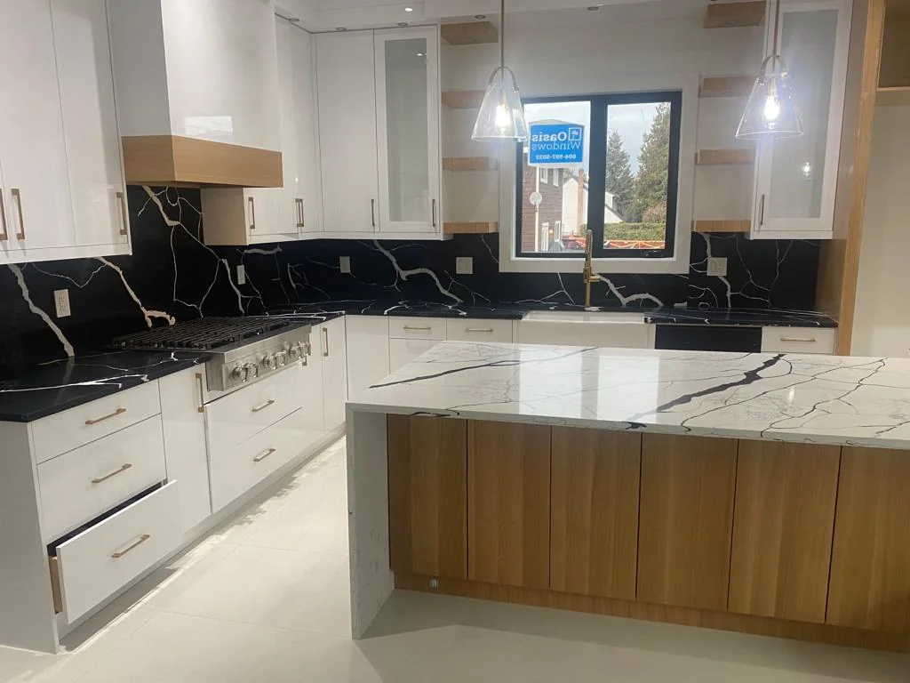 Wide kitchen view with black stone countertops.