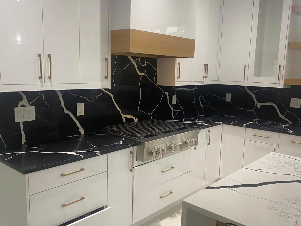 Kitchen with black countertop and white cabinets.