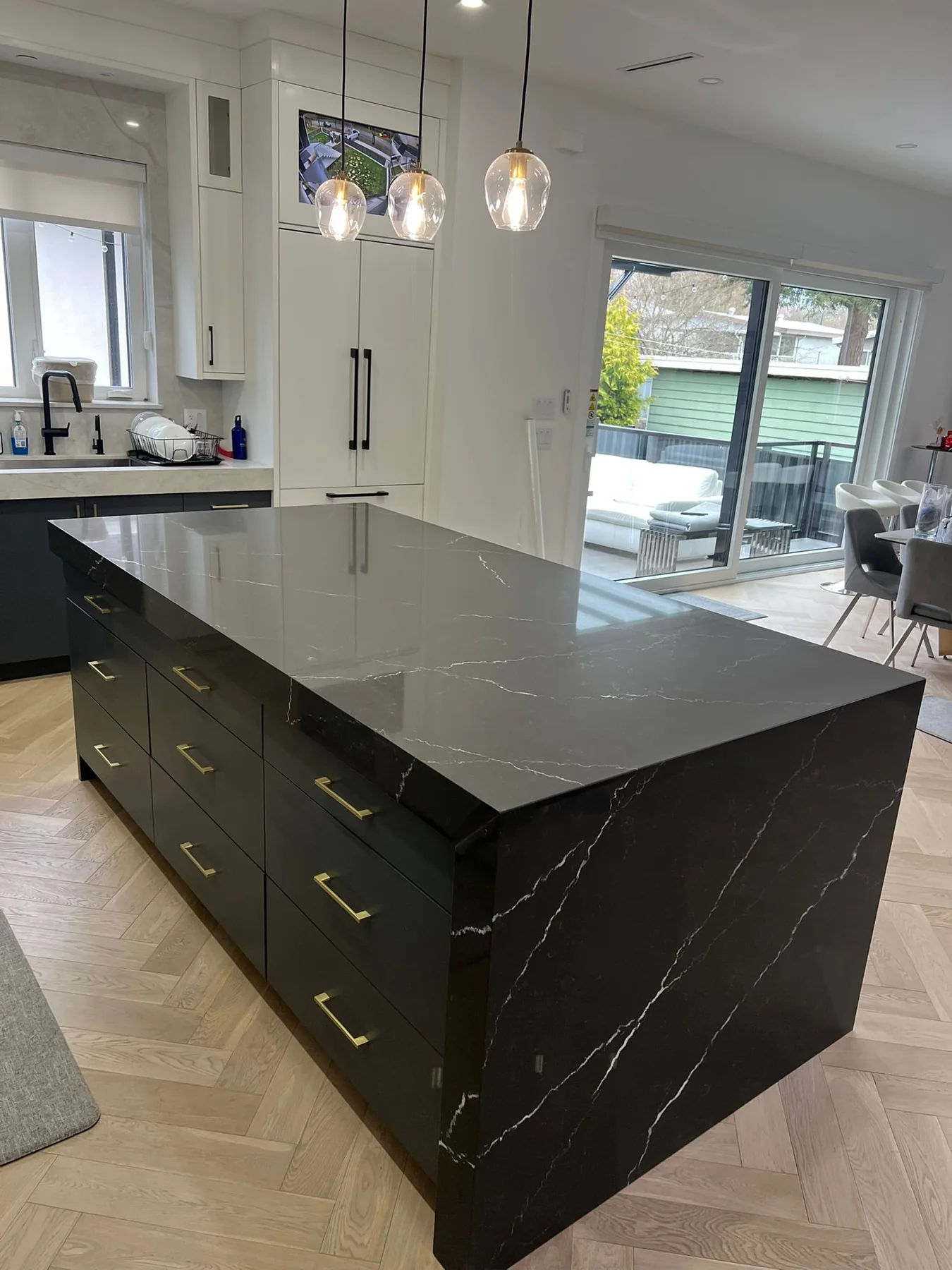 Dark kitchen island countertop with dramatic stone veining.