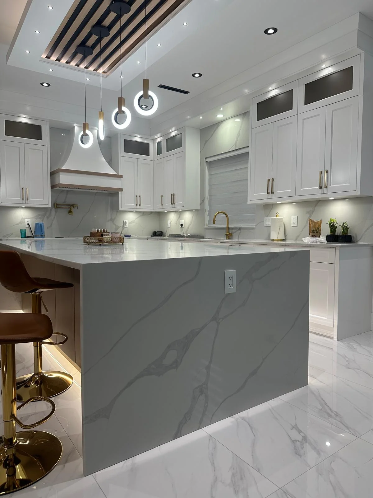 Grey vanity countertop with undermount sink and modern lighting.