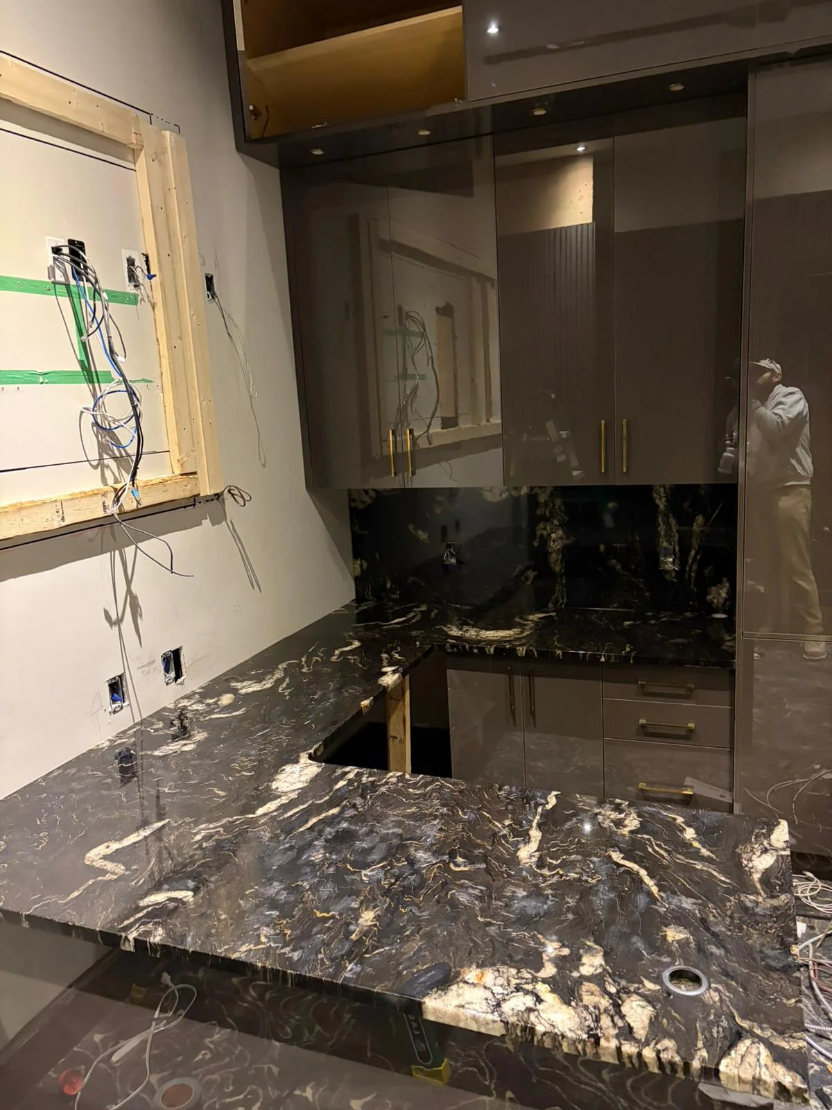 In-progress kitchen countertop installation with dark stone surface.