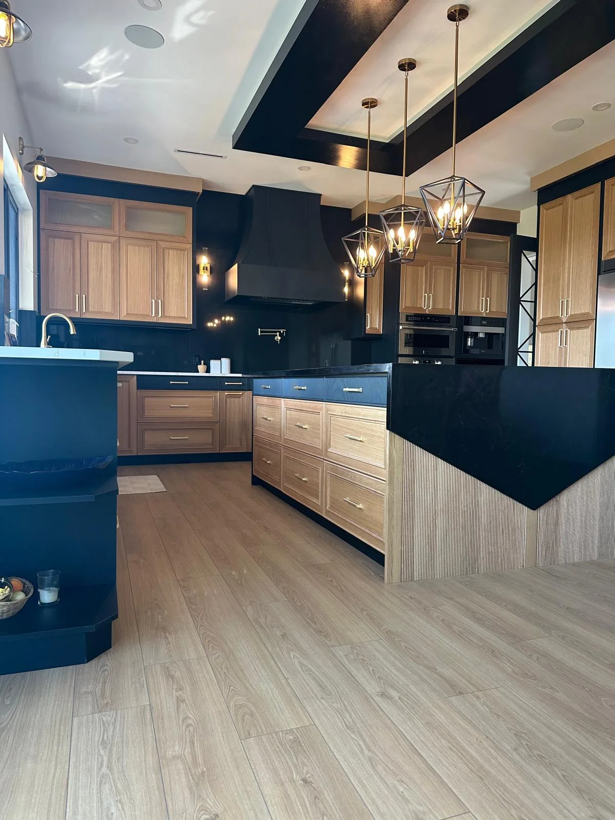 Kitchen with custom black stone island countertop fabricated by Orbit Granite Counters.