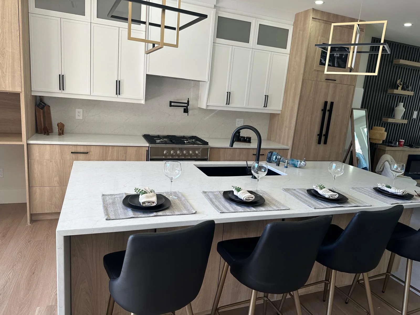 Modern kitchen island with light stone countertop and bar seating.