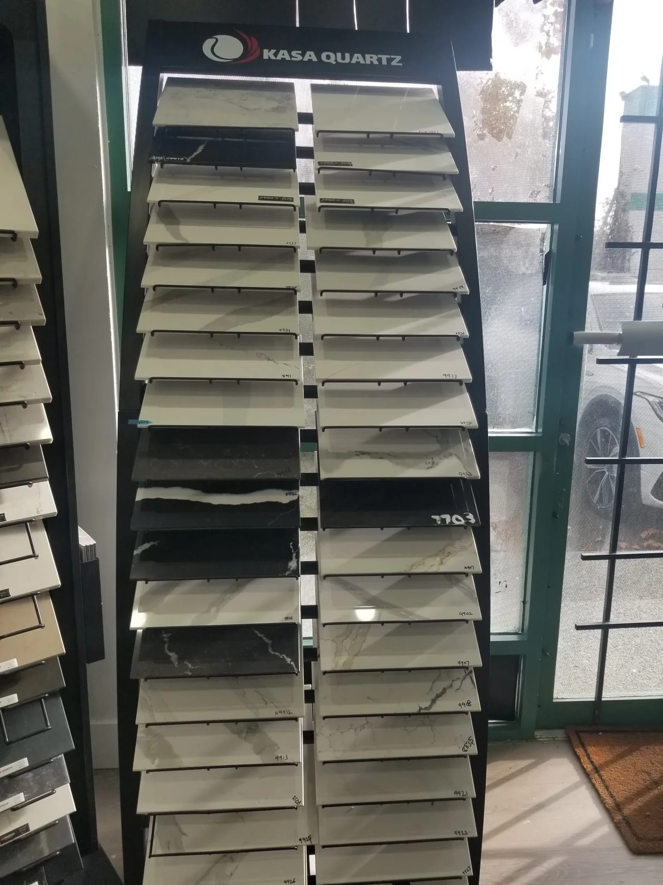 Stone and quartz sample display used for reviewing countertop colours and finishes.