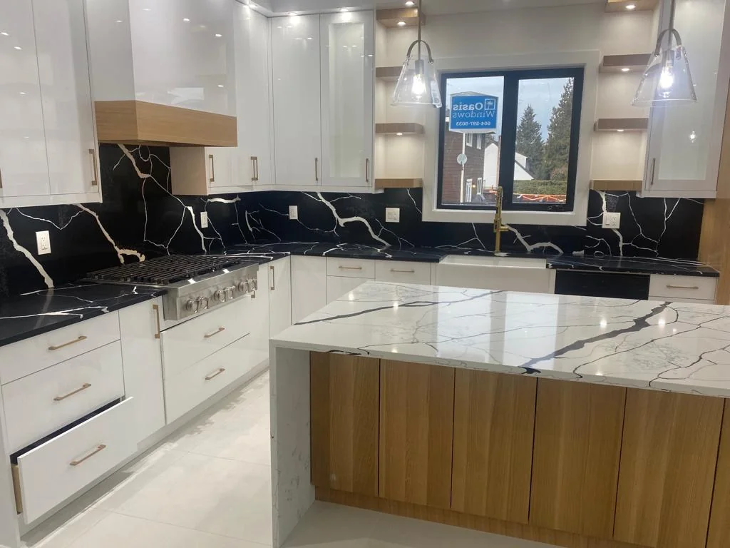 White kitchen cabinetry with black stone countertops.