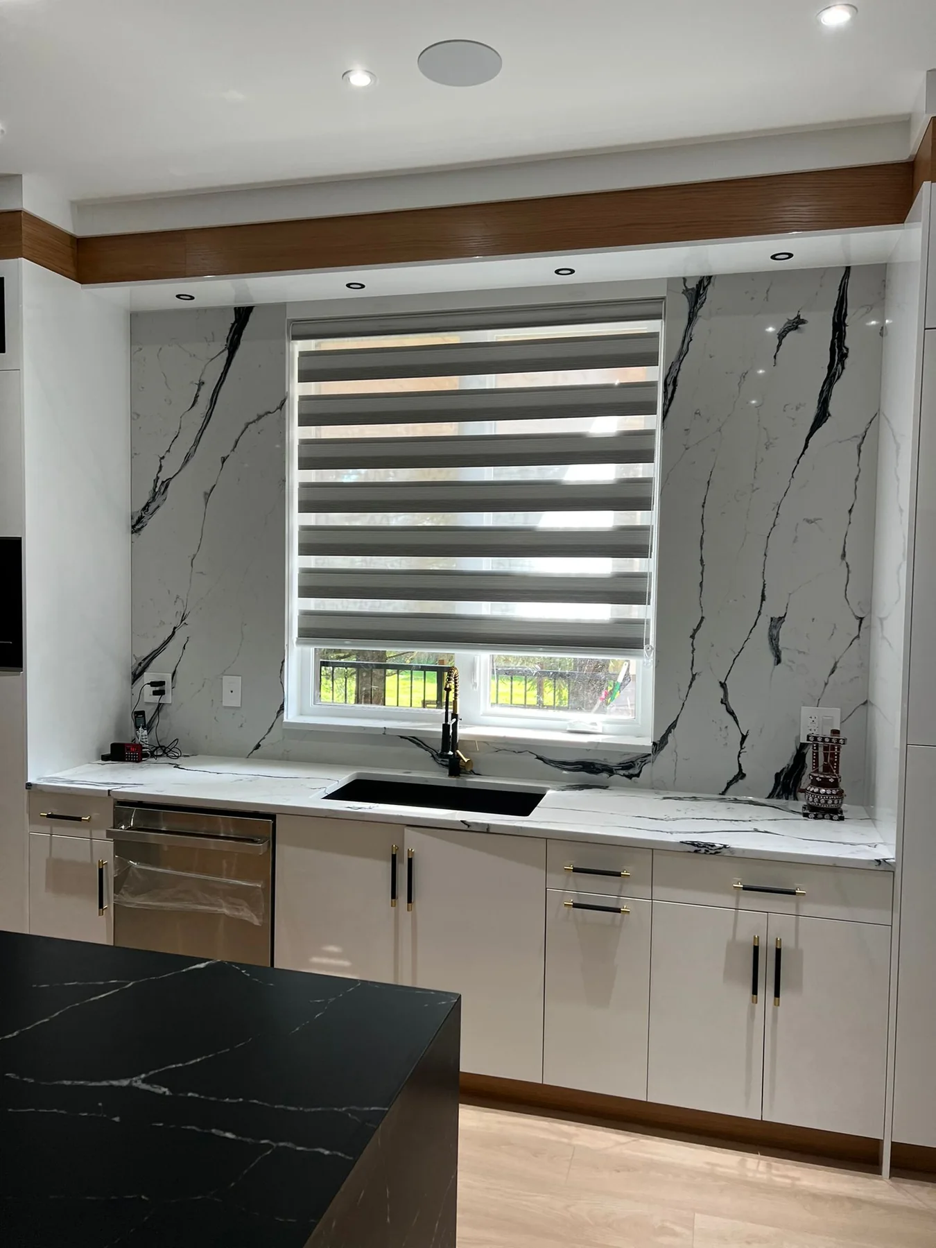 Kitchen countertop and backsplash surface around a window.